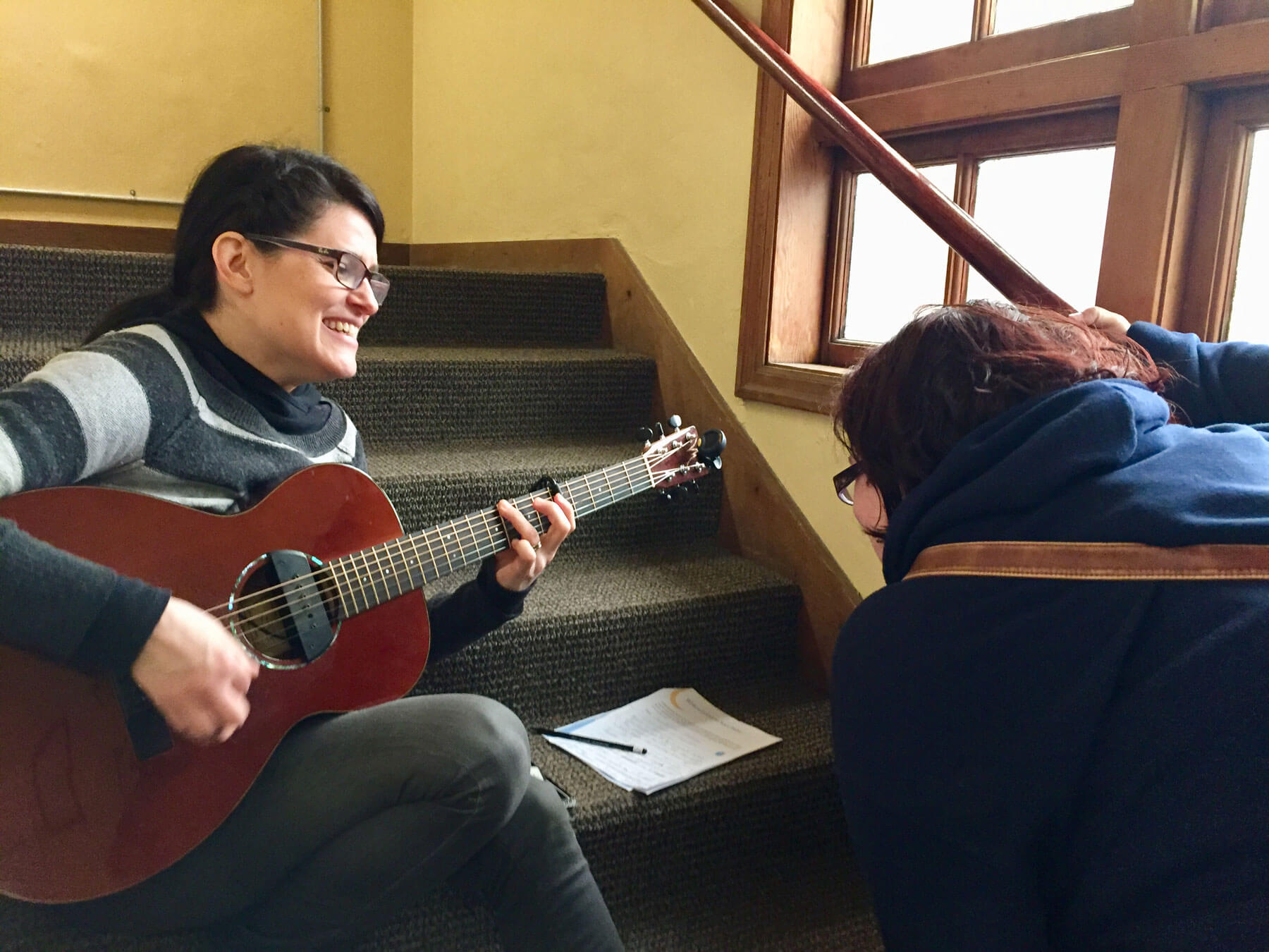 A singer-songwriter writes music with a mom