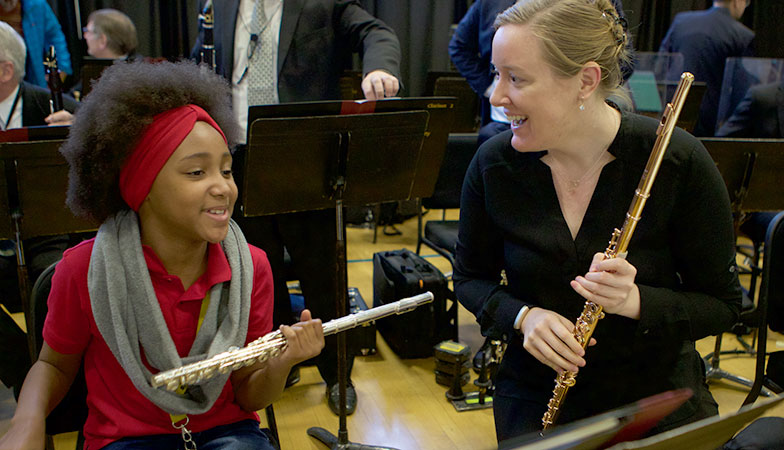 A flutist with a student